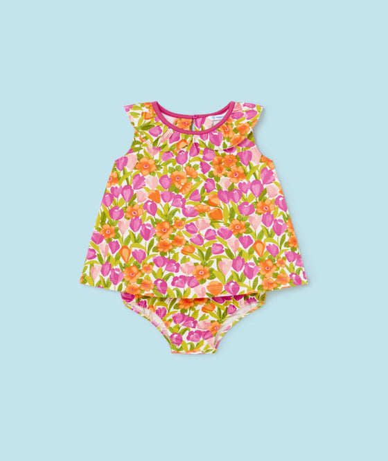 Vibrant floral baby romper with sleeveless design and colorful tulip print, perfect for summer outings