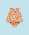 Bright and cheerful sleeveless baby romper featuring an all-over floral pattern in pink, orange, and green hues