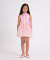 pink blouse with ruffled front and floral organza skirt with a big bow on the waist